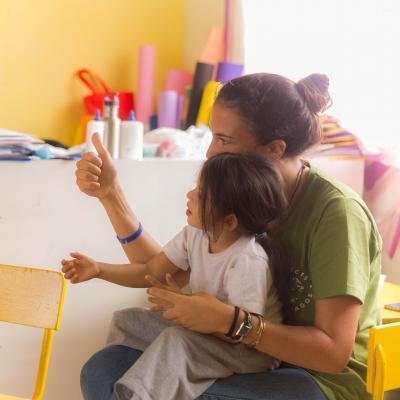 A Projects Abroad intern works with a child at her Social Work placement in Ecuador An intern working with a child and gaining social work experience in Ecuador